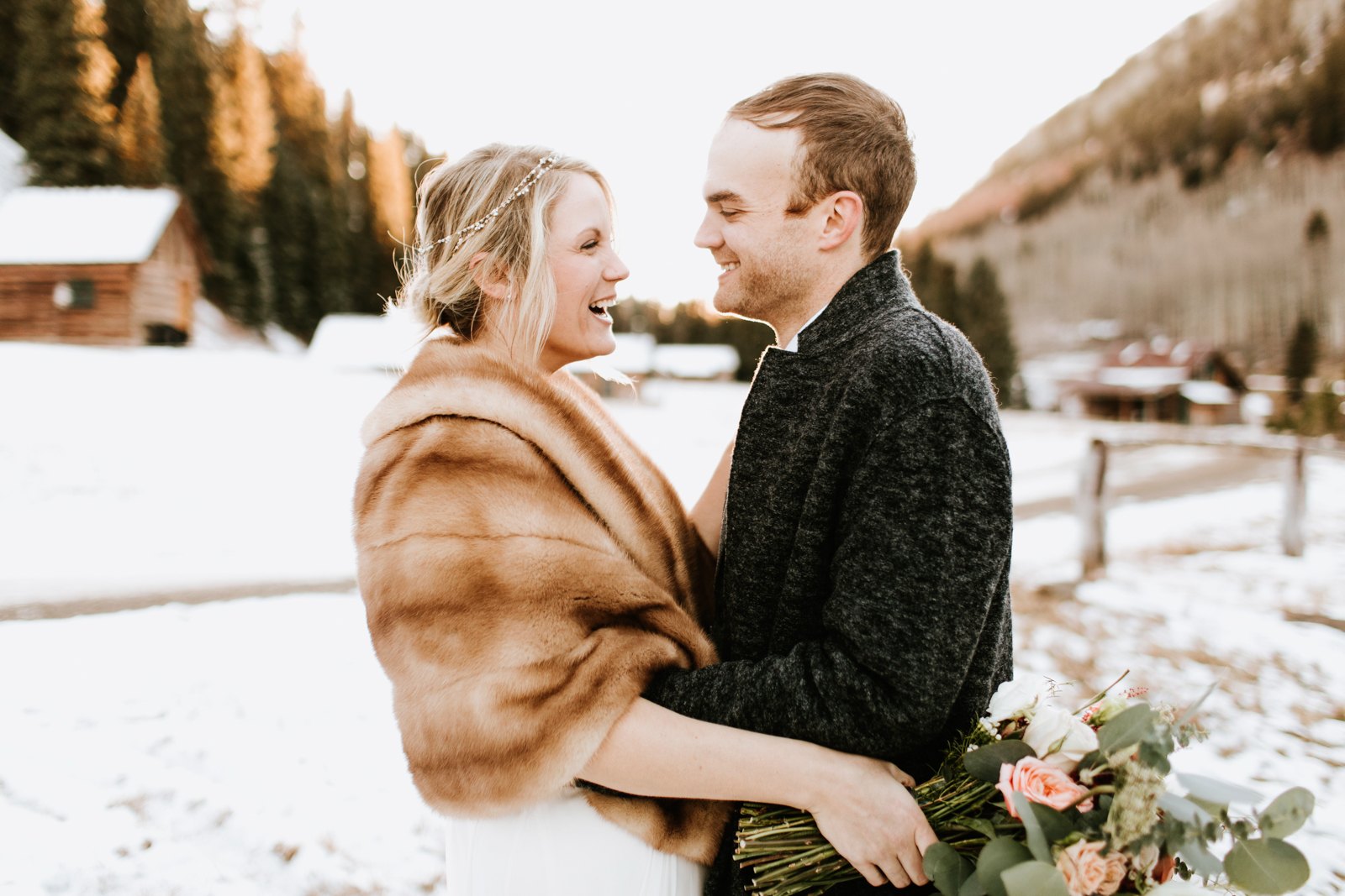 Esther and Austin laughing together in the snow at Dunton Hot Springs